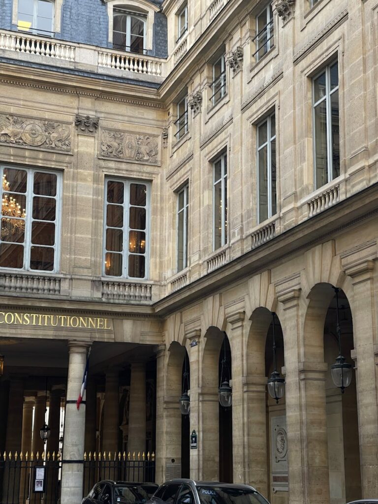 Elegant historic building with arched windows and stone facade.